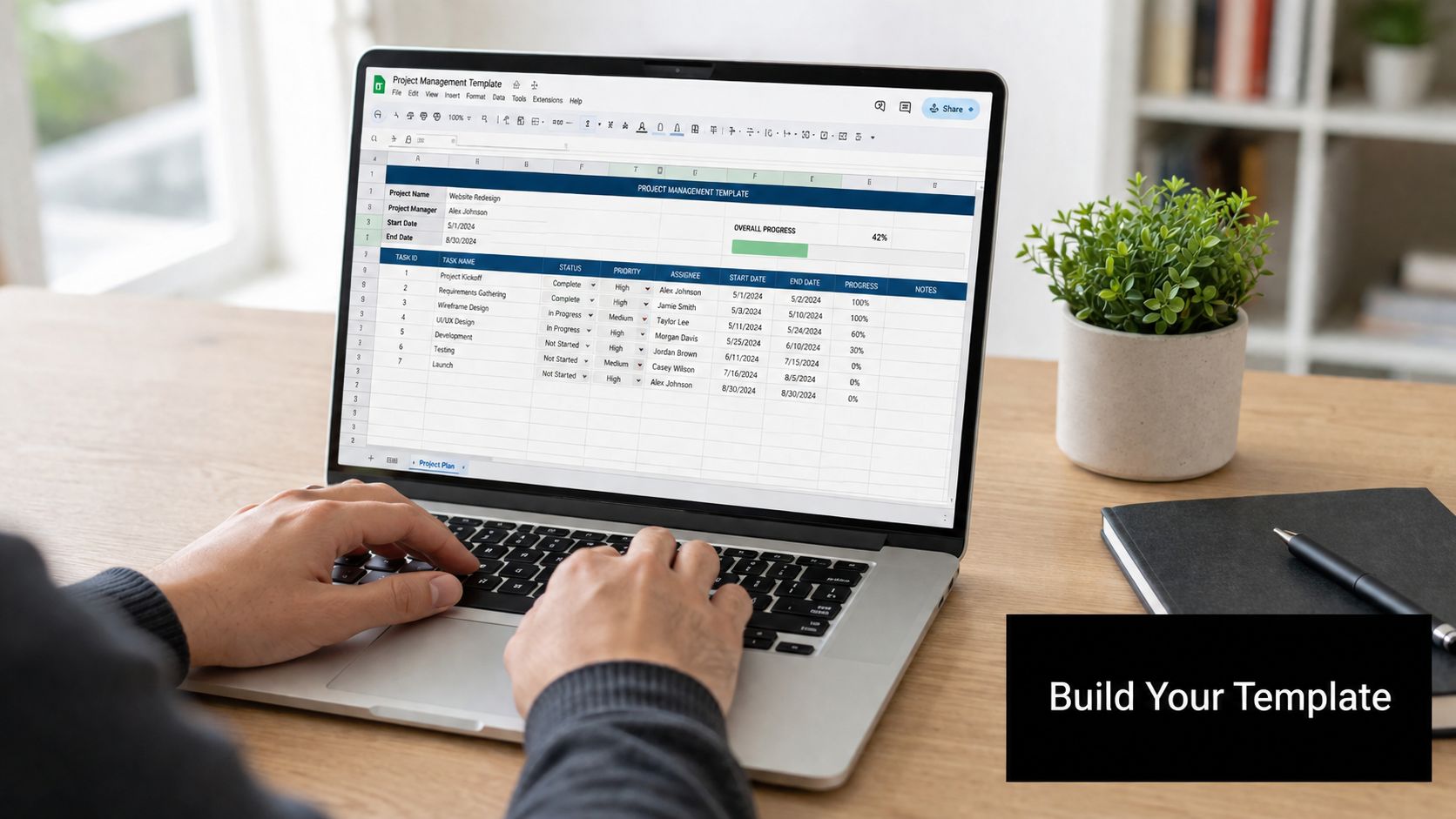 A person working on a laptop displaying a project management spreadsheet on a wooden desk.