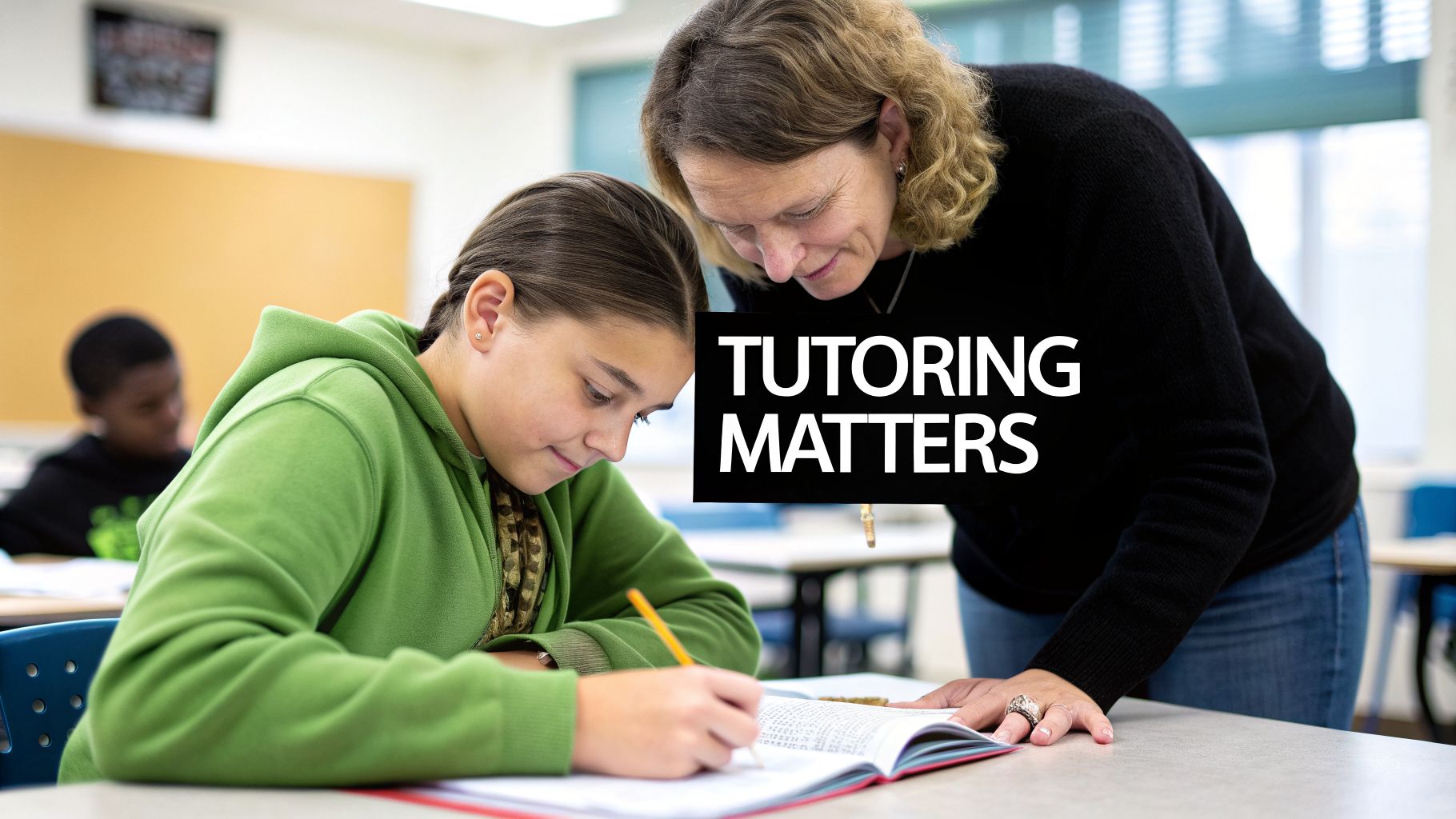 A female tutor leans over a young girl writing in a book during a tutoring session.