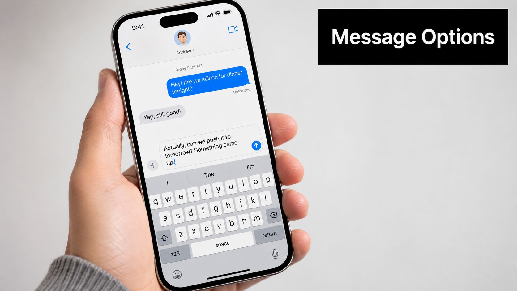 A close-up of a person holding an iPhone displaying a text conversation in the Messages app.