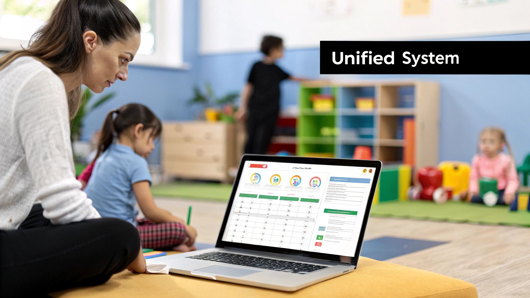 A woman views a comprehensive software interface on her laptop in a children's learning center.