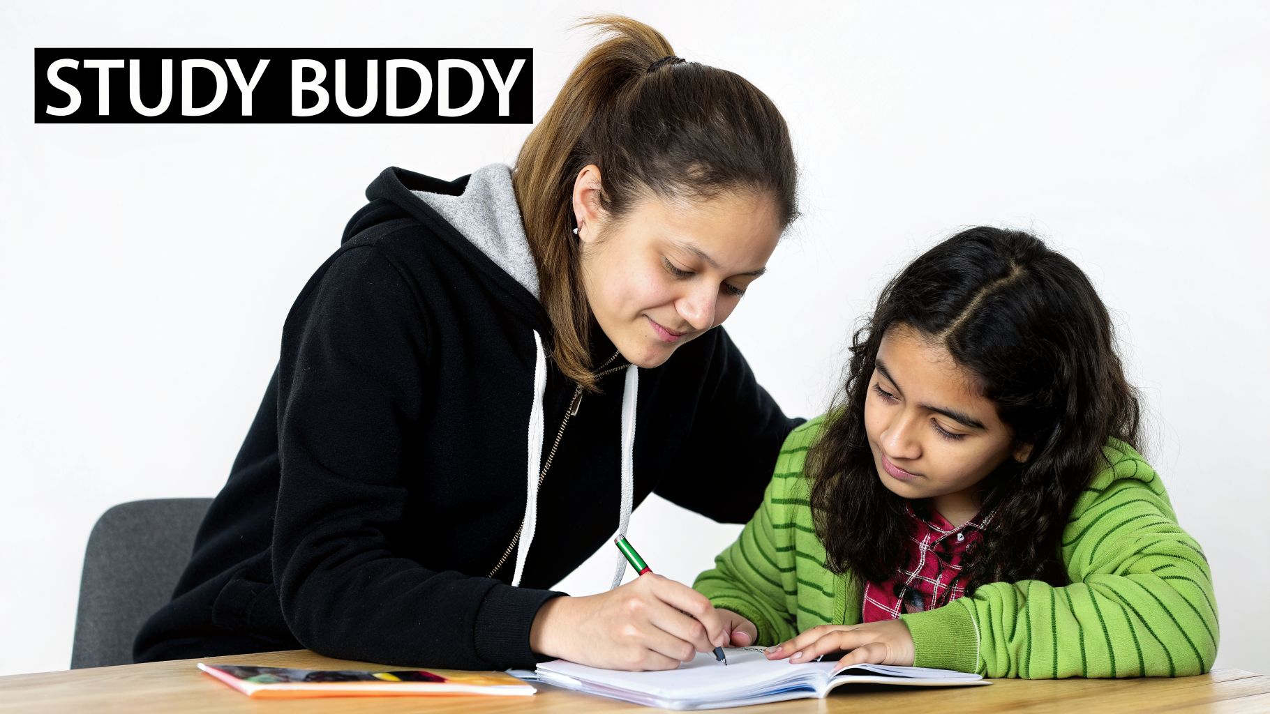 Two females, an older and a younger, are focused on writing in a notebook, acting as study buddies.