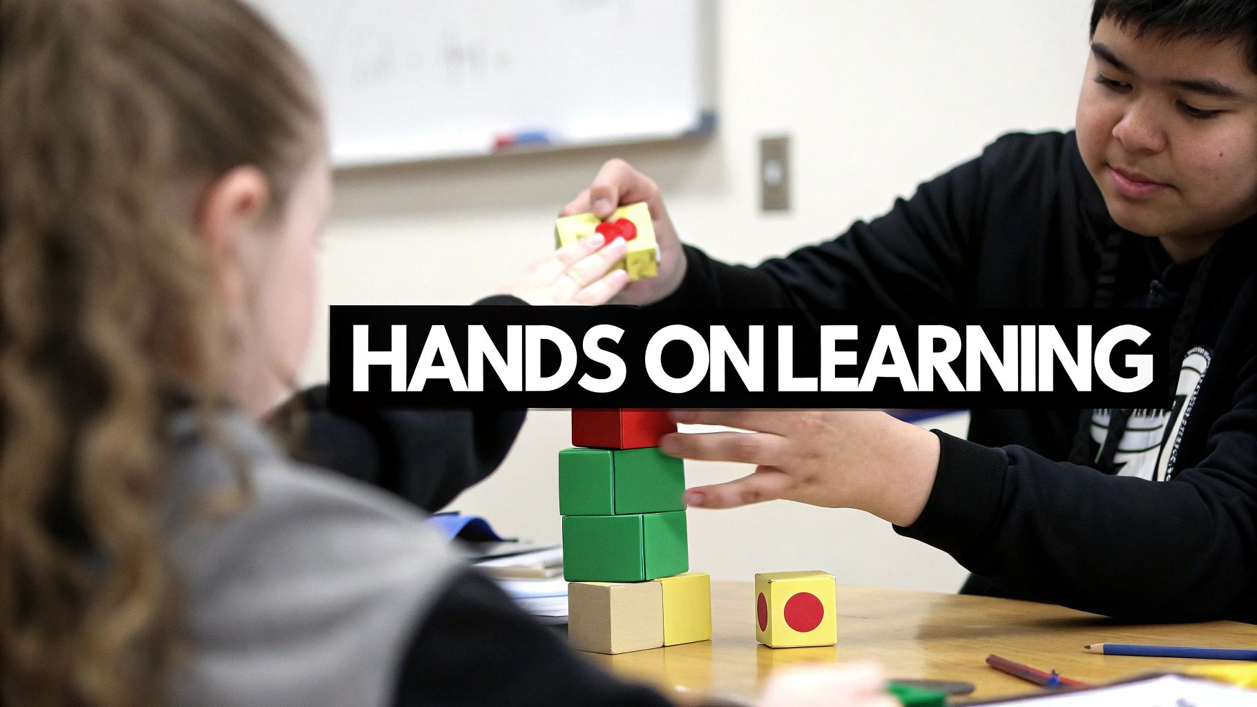 Two students engage in hands-on learning, building a colorful block tower in a classroom.